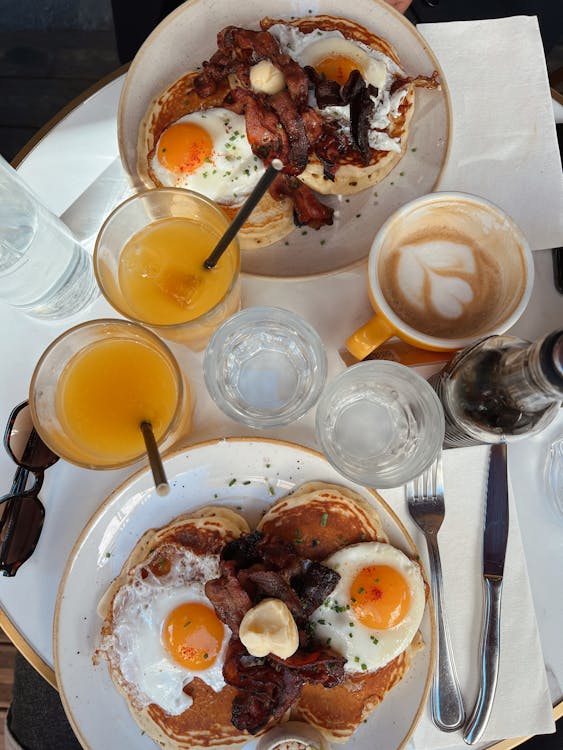 Free Eggs and Bacon Served on Breakfast in a Restaurant  Stock Photo