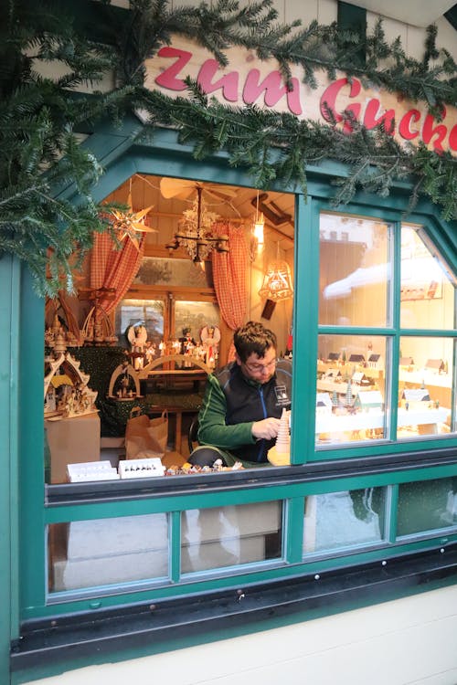 Free A craftsman at a festive Christmas market stall in Annaberg-Buchholz, Germany. Stock Photo