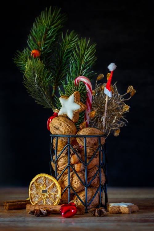 Free A festive Christmas arrangement featuring dried oranges, cookies, and fir branches. Stock Photo