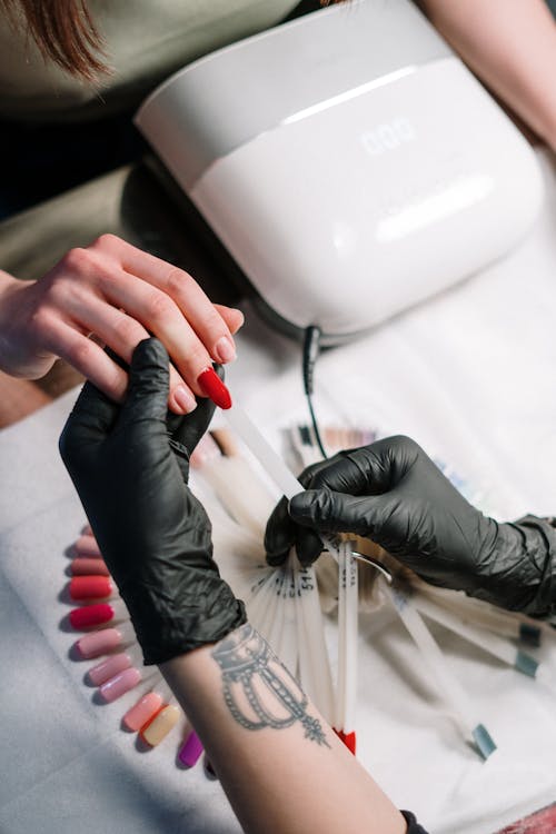 Free Close-up of a manicure session with nail polish color selection in a beauty salon. Stock Photo